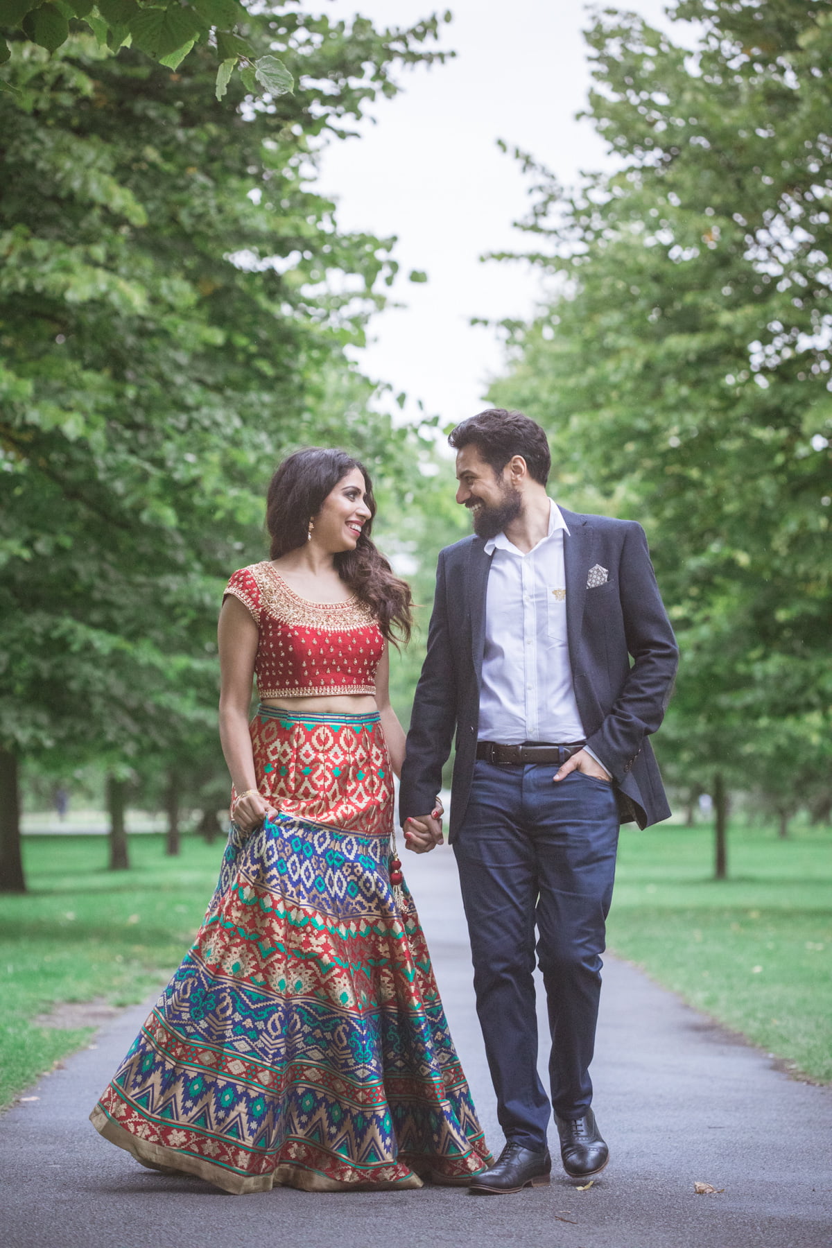 Walking with love during engagement photoshoot for Indian couple in Hyde Park, Kensington