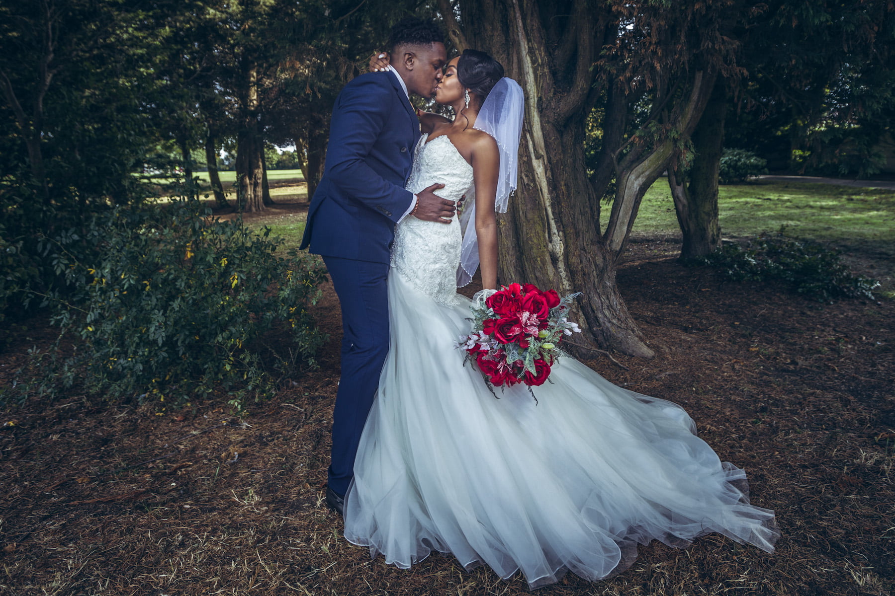 What a romantic kissing during couple photoshoot with stylish British Nigerian bride and groom